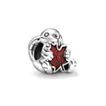 Otter Holding A Maple Leaf Charm